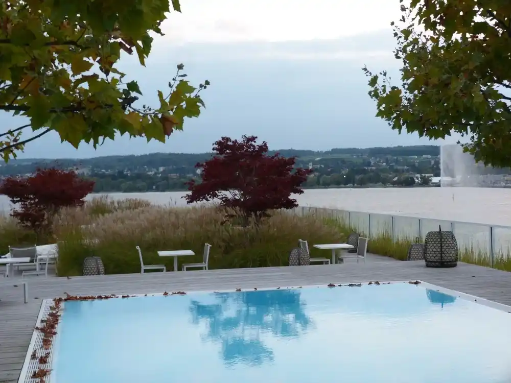 Outdoor swimming pool at Hotel Riva overlooking Lake Constance.