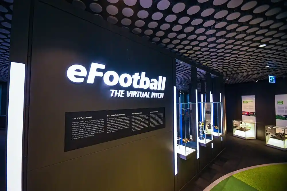 eFootball exhibition inside the FIFA World Football Museum in Zurich exploring football gaming culture and virtual competition.