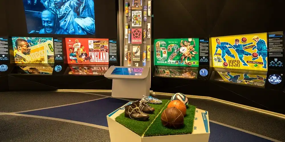 Historic football displays and World Cup memorabilia inside the FIFA World Football Museum in Zurich, featuring vintage footballs, boots and colourful tournament posters.