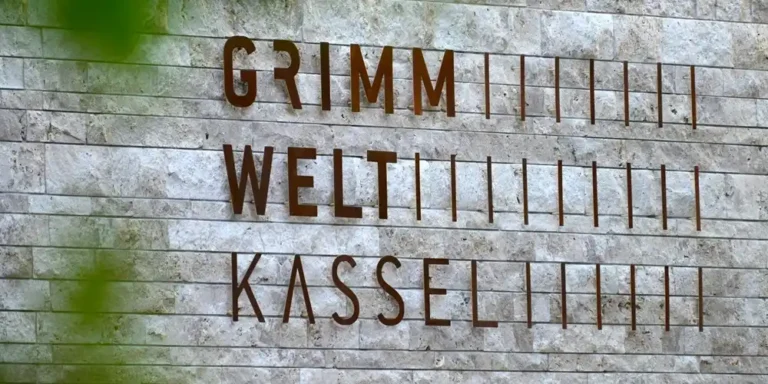 GRIMMWELT Kassel museum exterior sign on stone wall in Kassel Germany.